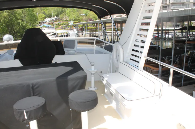 Slide: The Image of 1984 Broward CPMY yacht with raised pilothouse, outdoor seating area. - 28