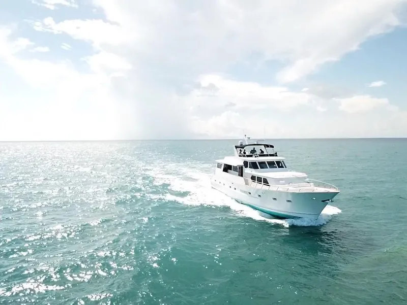 Slide: The Image of 1984 Broward CPMY yacht cruising on open sea under sunny skies. - 3