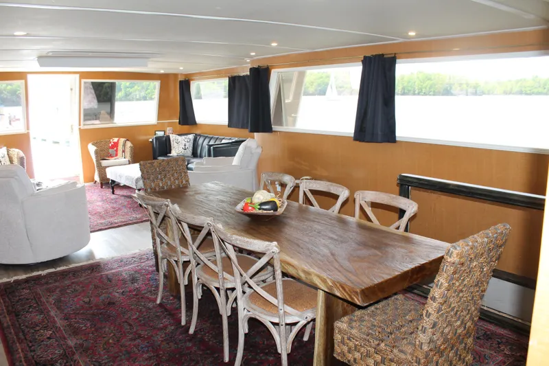 Slide: The Image of Interior of a 1984 Broward CPMY yacht with dining table. - 42