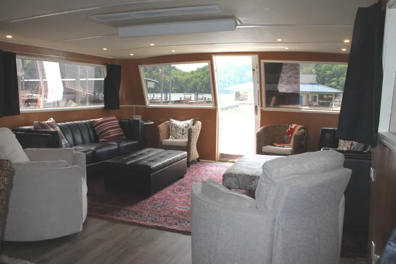 Slide: The Image of Interior of a 1984 Broward CPMY yacht with cozy seating area. - 43