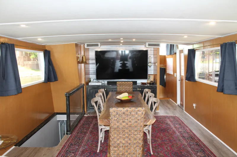 Slide: The Image of Interior of 1984 Broward CPMY with dining area and TV. - 44