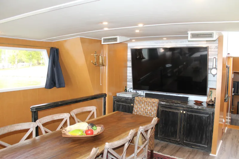 Slide: The Image of Interior of 1984 Broward CPMY with dining table and TV. - 46