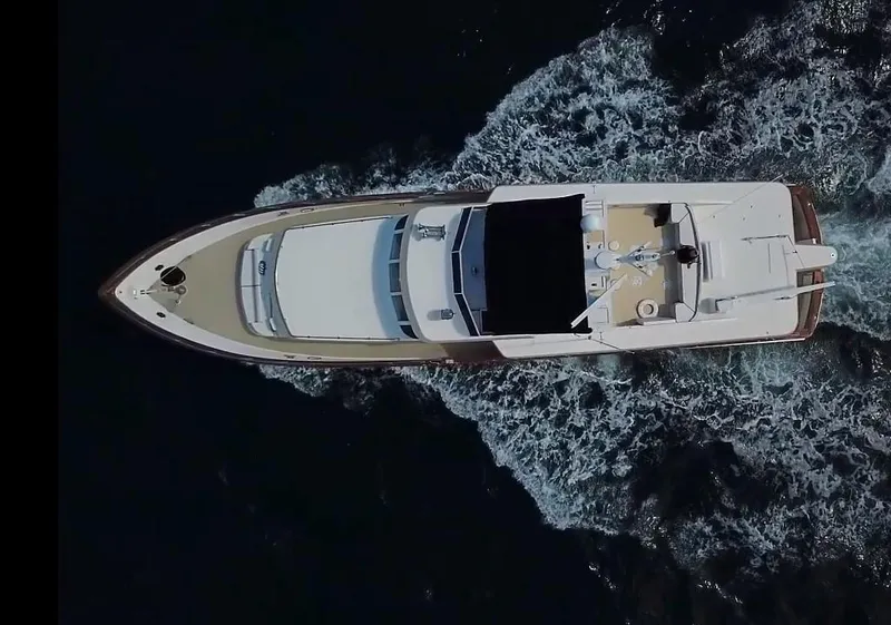 Slide: The Image of Aerial view of a 1984 Broward CPMY yacht on the water. - 6