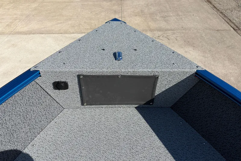 Slide: The Image of 2026 Lund 1775 Adventure SS boat interior with gray carpet and storage compartment. - 10