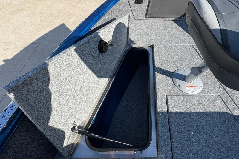 Slide: The Image of 2026 Lund 1775 Adventure SS boat interior with open storage compartment and seat. - 11