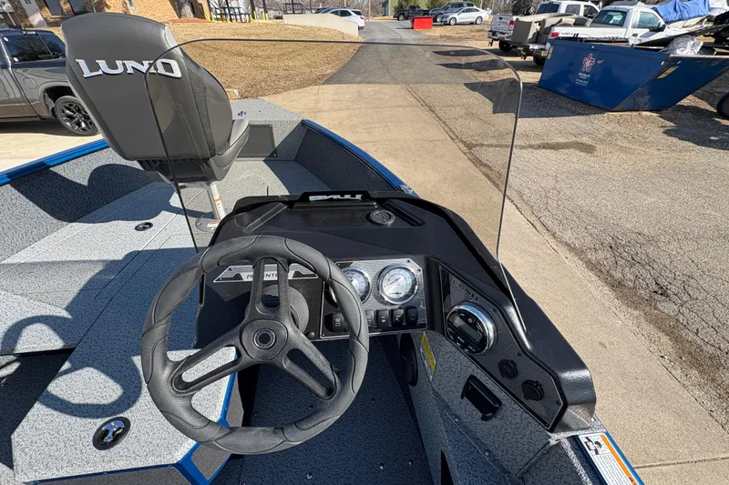 Slide: The Image of 2026 Lund 1775 Adventure SS boat interior with steering wheel and dashboard controls. - 16