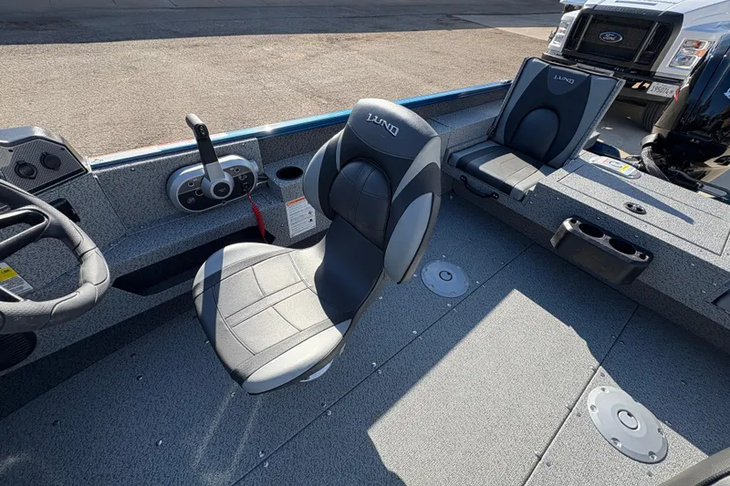 Slide: The Image of 2026 Lund 1775 Adventure SS boat interior with steering wheel and seating. - 19