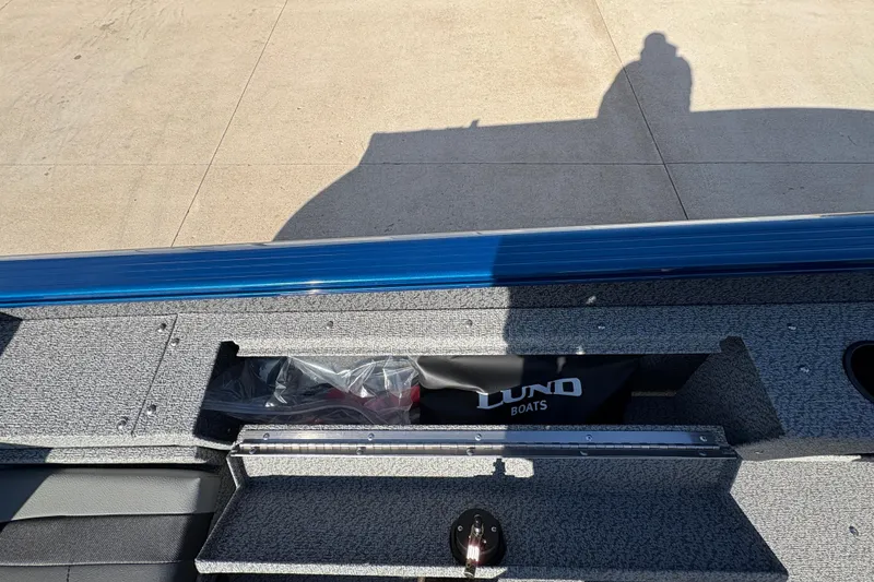 Slide: The Image of 2026 Lund 1775 Adventure SS boat interior with storage compartment open. - 21