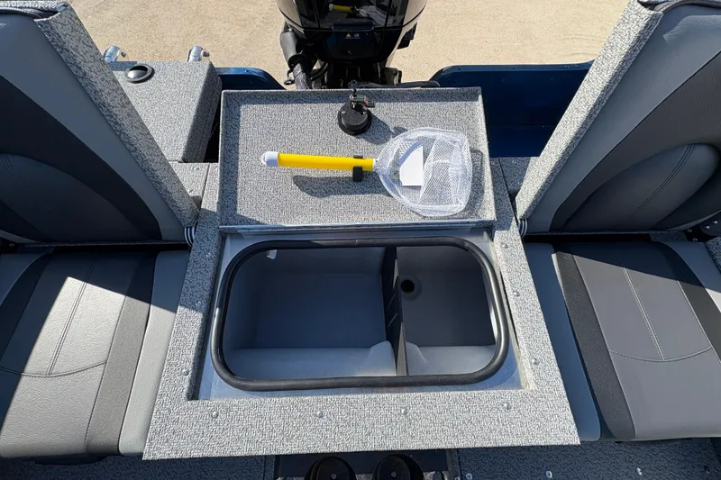 Slide: The Image of 2026 Lund 1775 Adventure SS boat interior with storage compartment and fishing net. - 23