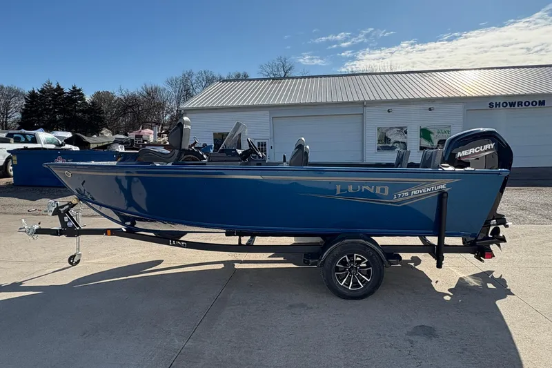 Slide: The Image of 2026 Lund 1775 Adventure SS boat on trailer outside showroom. - 4
