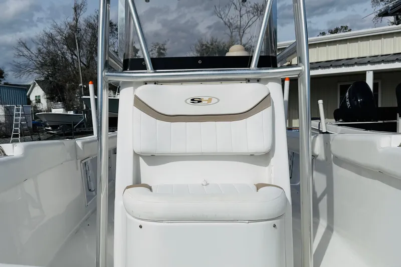 Slide: The Image of Interior seating of a 2012 Sea Hunt Ultra 211 boat, featuring white cushioned seats. - 10
