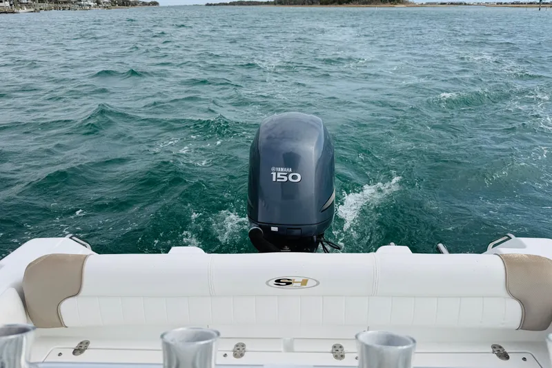 Slide: The Image of Red life jackets stored in a 2012 Sea Hunt Ultra 211 boat compartment. - 12