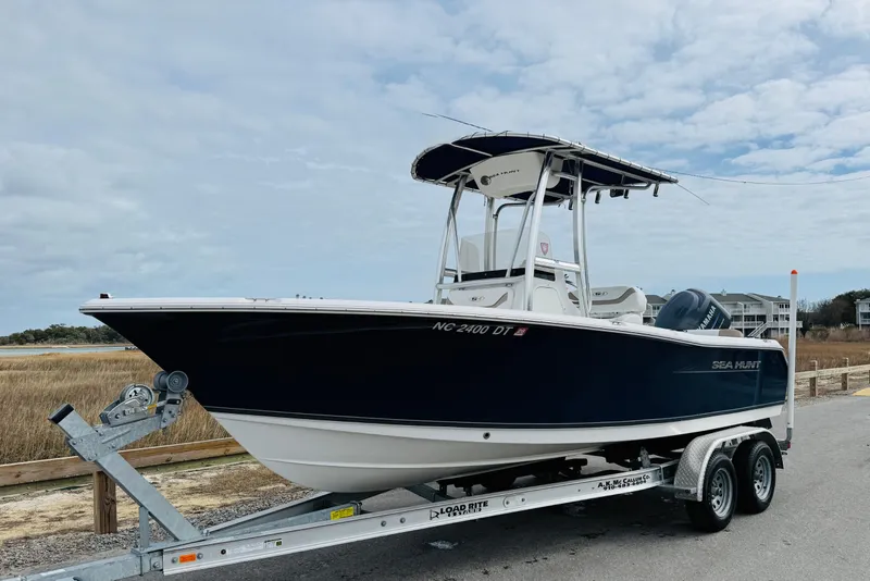 Slide: The Image of 2012 Sea Hunt Ultra 211 boat interior with cushioned seating and Yamaha engine. - 7