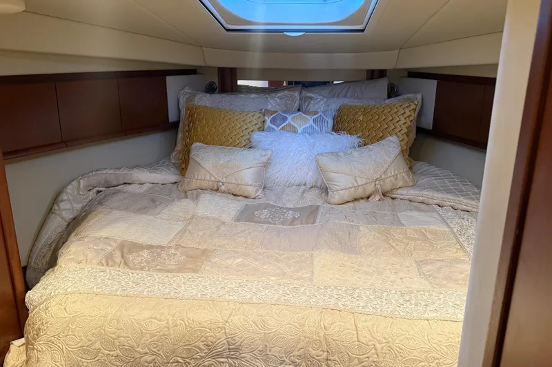 Slide: The Image of Luxurious cabin interior of 2007 Sea Ray Sundancer 400 with plush bedding and skylight. - 16