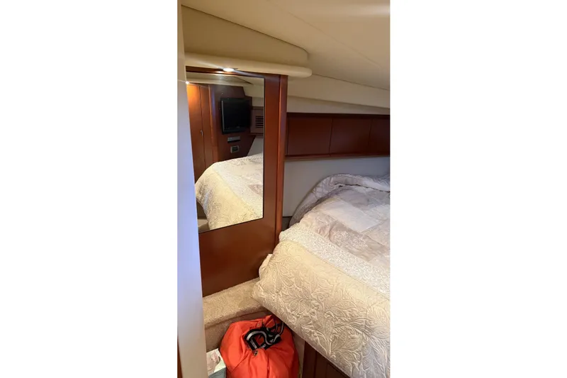 Slide: The Image of Interior cabin of 2007 Sea Ray Sundancer 400 with bed, mirror, and TV. - 17