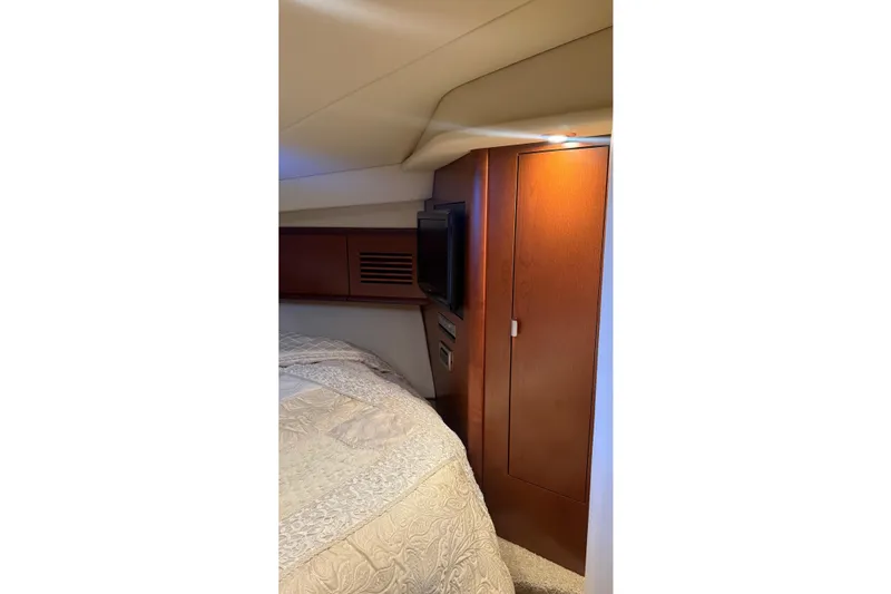 Slide: The Image of Interior cabin of 2007 Sea Ray Sundancer 400 with wood paneling and cozy bedding. - 18