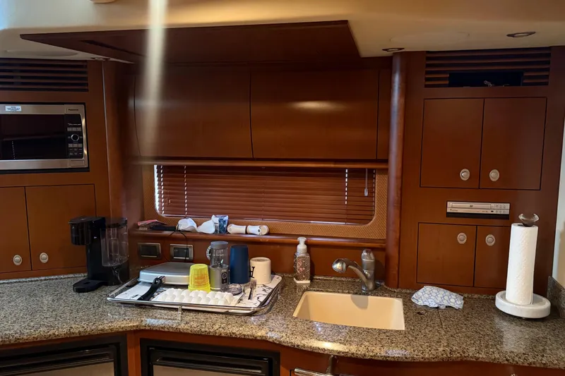 Slide: The Image of 2007 Sea Ray Sundancer 400 kitchen with granite countertops, sink, and wooden cabinetry. - 22