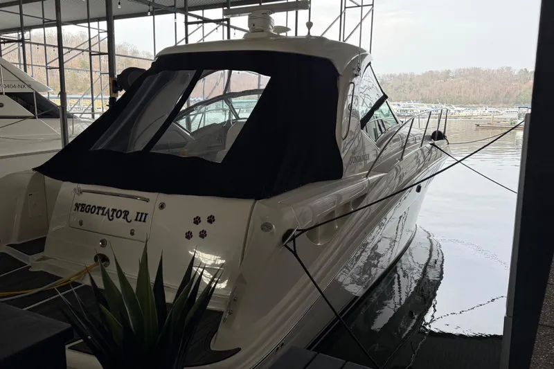 Slide: The Image of 2007 Sea Ray Sundancer 400 docked, featuring sleek design and covered cockpit. - 6