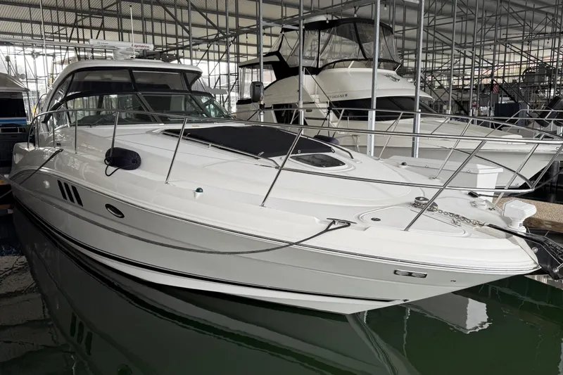 Slide: The Image of 2007 Sea Ray Sundancer 400 yacht docked in a marina under a covered structure. - 7