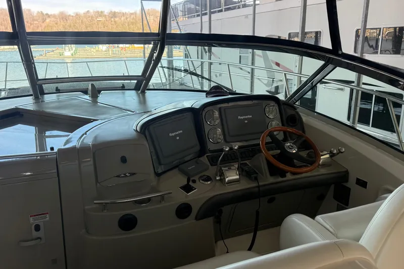 Slide: The Image of 2007 Sea Ray Sundancer 400 helm with Raymarine navigation system and leather steering wheel. - 8