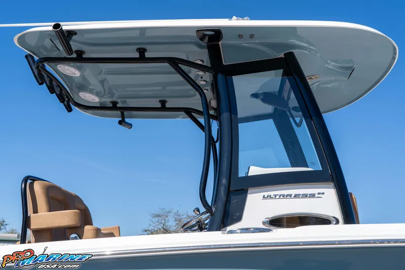 Slide: The Image of 2023 Sea Hunt Ultra 255 SE boat with sleek T-top design against blue sky. - 12
