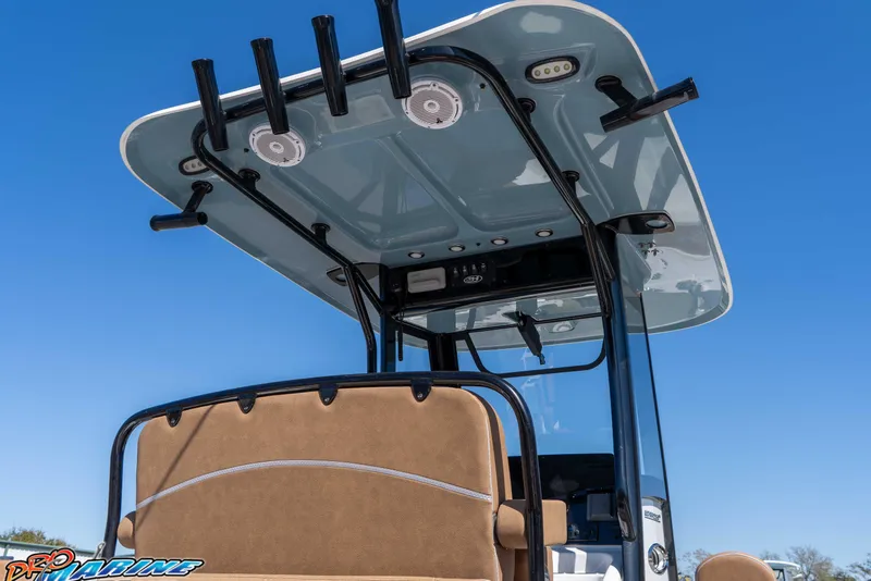 Slide: The Image of 2023 Sea Hunt Ultra 255 SE boat with T-top and rod holders against clear blue sky. - 13