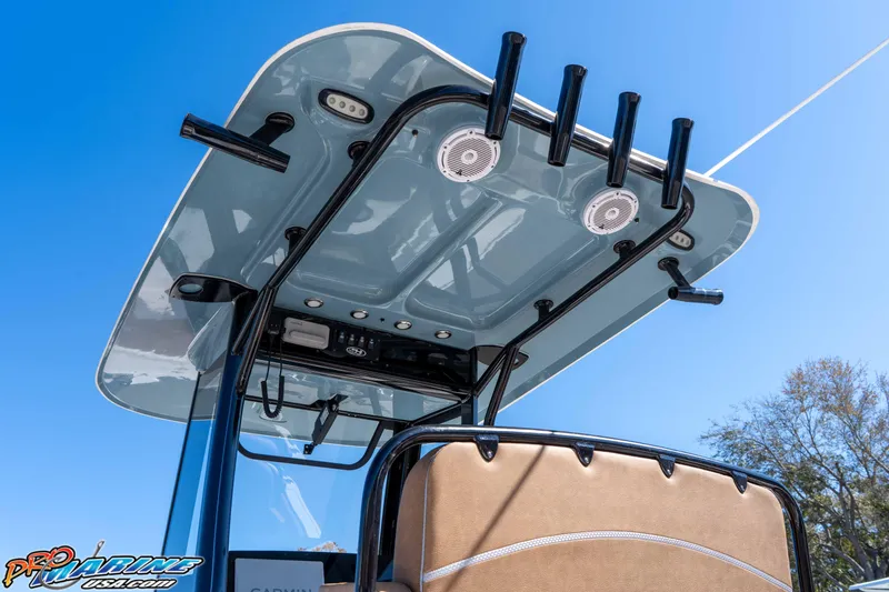 Slide: The Image of 2023 Sea Hunt Ultra 255 SE boat with T-top and rod holders under clear blue sky. - 15