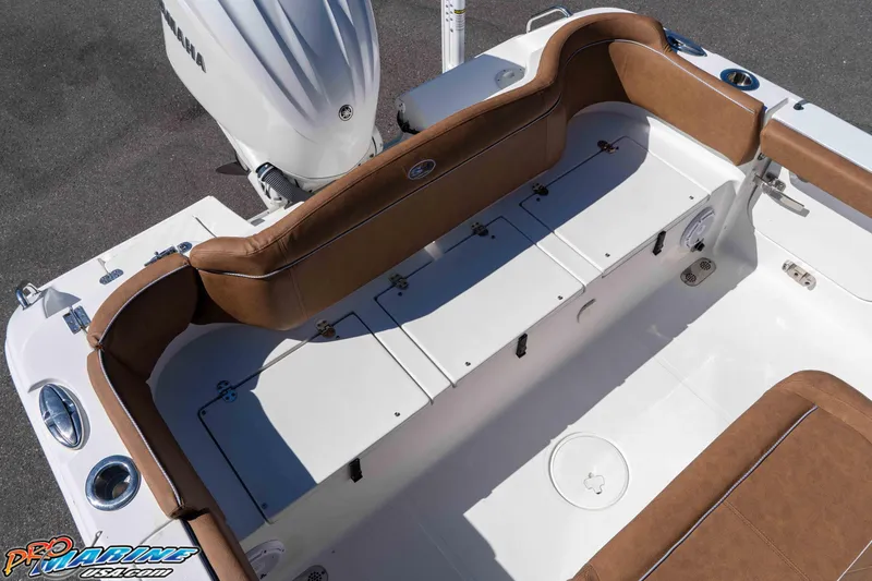 Slide: The Image of 2023 Sea Hunt Ultra 255 SE boat interior with brown seating and Yamaha engine. - 16