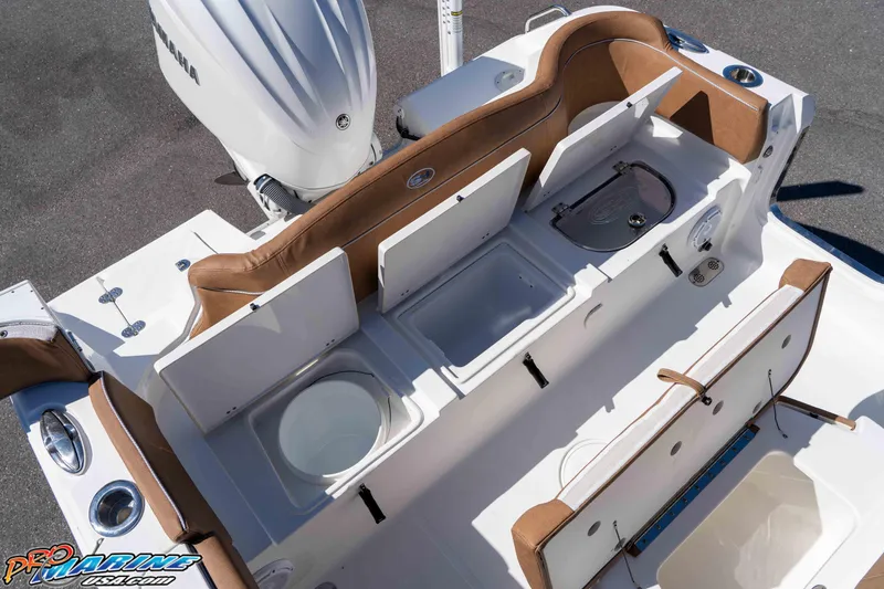 Slide: The Image of 2023 Sea Hunt Ultra 255 SE boat interior with storage compartments and seating. - 17
