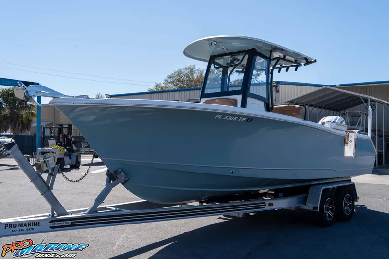 The Image of 2023 Sea Hunt Ultra 255 SE boat on trailer at marina. - 2