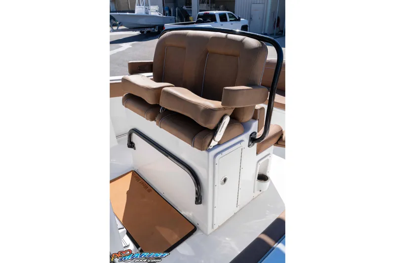 Slide: The Image of 2023 Sea Hunt Ultra 255 SE boat seating with brown cushions and armrests. - 23