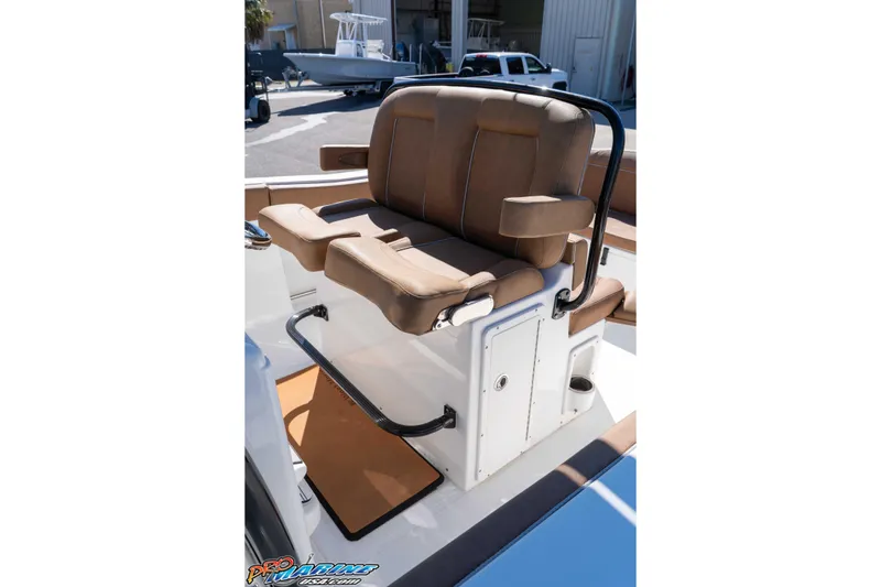 Slide: The Image of 2023 Sea Hunt Ultra 255 SE boat seating with brown cushions and storage compartment. - 24