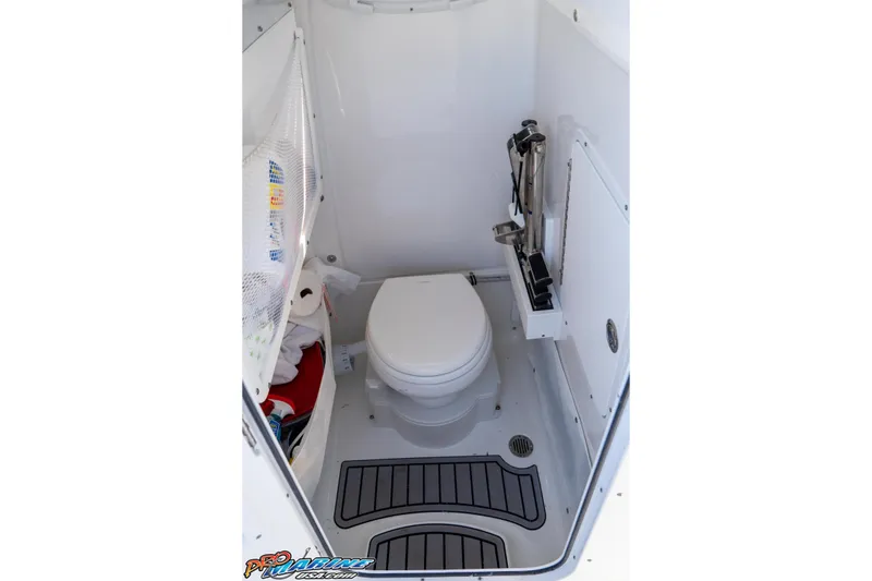 Slide: The Image of 2023 Sea Hunt Ultra 255 SE boat interior bathroom with toilet and storage. - 30