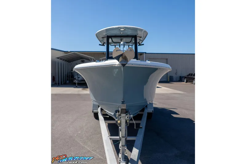 Slide: The Image of 2023 Sea Hunt Ultra 255 SE boat on trailer, front view, in a marina setting. - 33