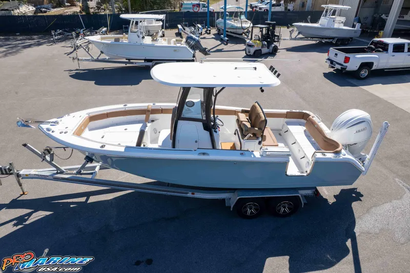 Slide: The Image of 2023 Sea Hunt Ultra 255 SE boat on trailer in marina setting. - 41