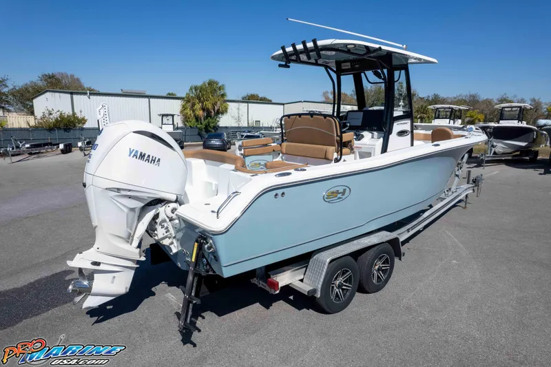 Slide: The Image of 2023 Sea Hunt Ultra 255 SE boat on trailer with Yamaha engine in a marina. - 47