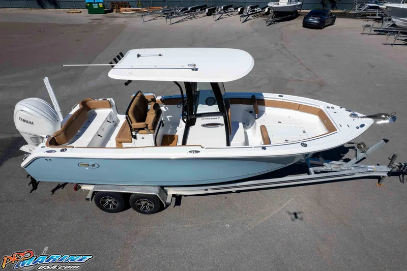 Slide: The Image of 2023 Sea Hunt Ultra 255 SE boat on trailer, featuring Yamaha engine, in a parking lot. - 51
