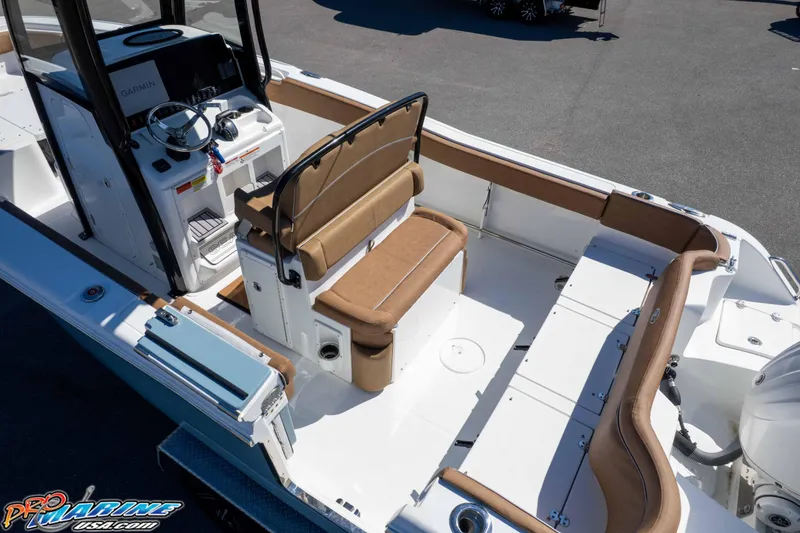 Slide: The Image of 2023 Sea Hunt Ultra 255 SE boat interior with tan seating and modern helm. - 54