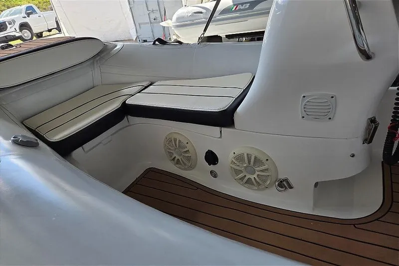 Slide: The Image of 2021 Walker Bay Generation 360 boat interior with cushioned seating and speakers. - 10