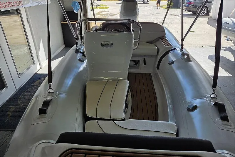 Slide: The Image of 2021 Walker Bay Generation 360 boat interior with Tohatsu 50HP engine, featuring sleek seating and controls. - 3