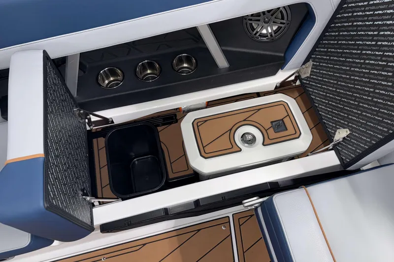 Slide: The Image of 2026 Nautique Super Air Nautique GS22 interior storage with cooler and cup holders. - 14
