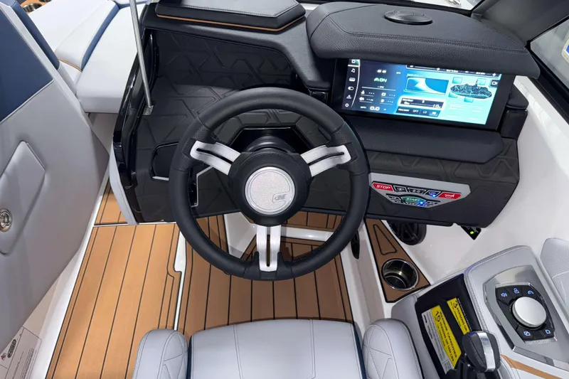 Slide: The Image of 2026 Nautique Super Air Nautique GS22 dashboard with modern steering and touchscreen controls. - 19
