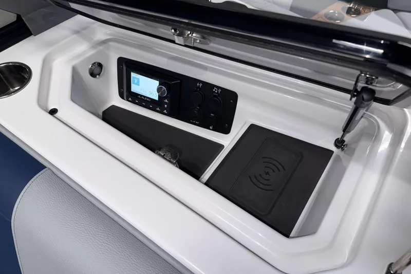 Slide: The Image of 2026 Nautique Super Air Nautique GS22 dashboard with audio controls and wireless charging pad. - 26