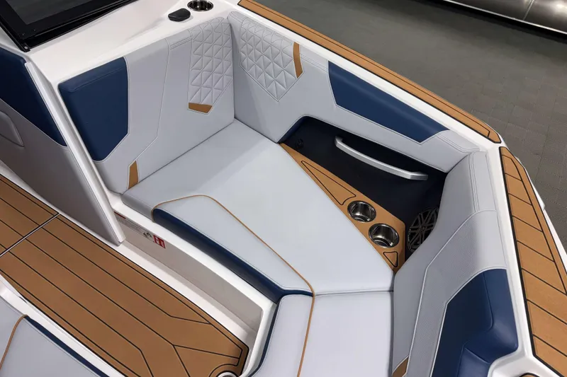 Slide: The Image of 2026 Nautique Super Air Nautique GS22 interior with blue and white seating, cup holders. - 30