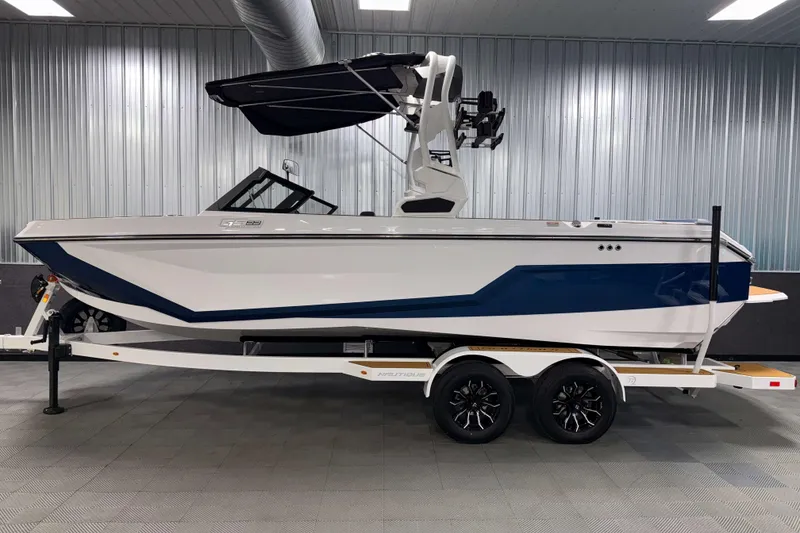 Slide: The Image of 2026 Nautique Super Air Nautique GS22 boat on trailer in indoor showroom. - 34