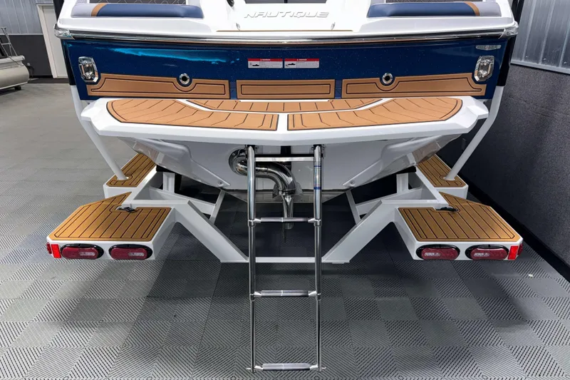 Slide: The Image of 2026 Nautique Super Air Nautique GS22 boat rear view with swim platform and ladder. - 37