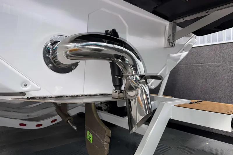 Slide: The Image of 2026 Nautique Super Air Nautique GS22 exhaust system detail in a showroom setting. - 38