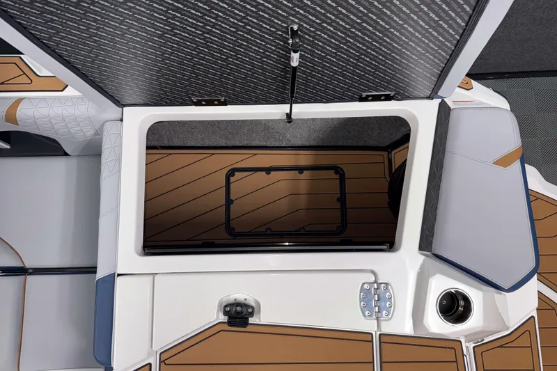 Slide: The Image of 2026 Nautique Super Air Nautique GS22 interior storage compartment with sleek design and wood accents. - 6