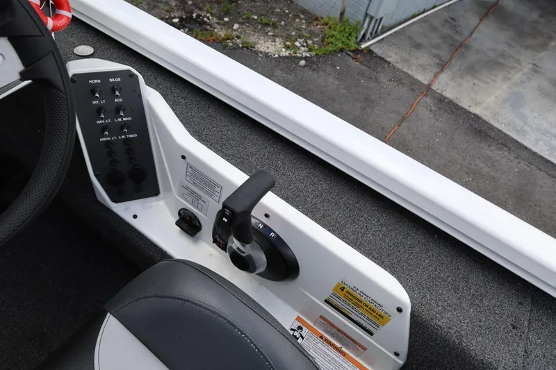 Slide: The Image of 2023 Vexus AVX189 boat control panel with steering wheel and throttle lever. - 10