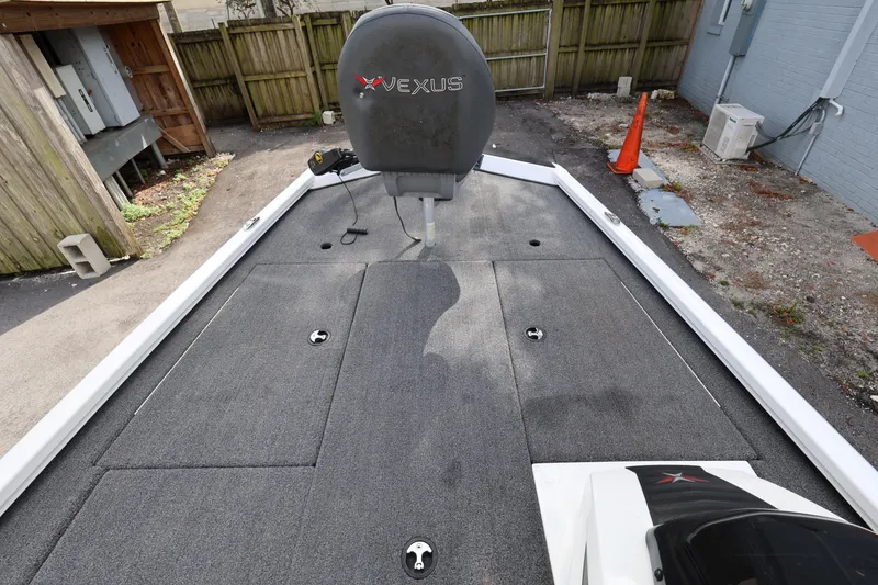 Slide: The Image of 2023 Vexus AVX189 boat deck with gray carpeting and seating in a driveway. - 12